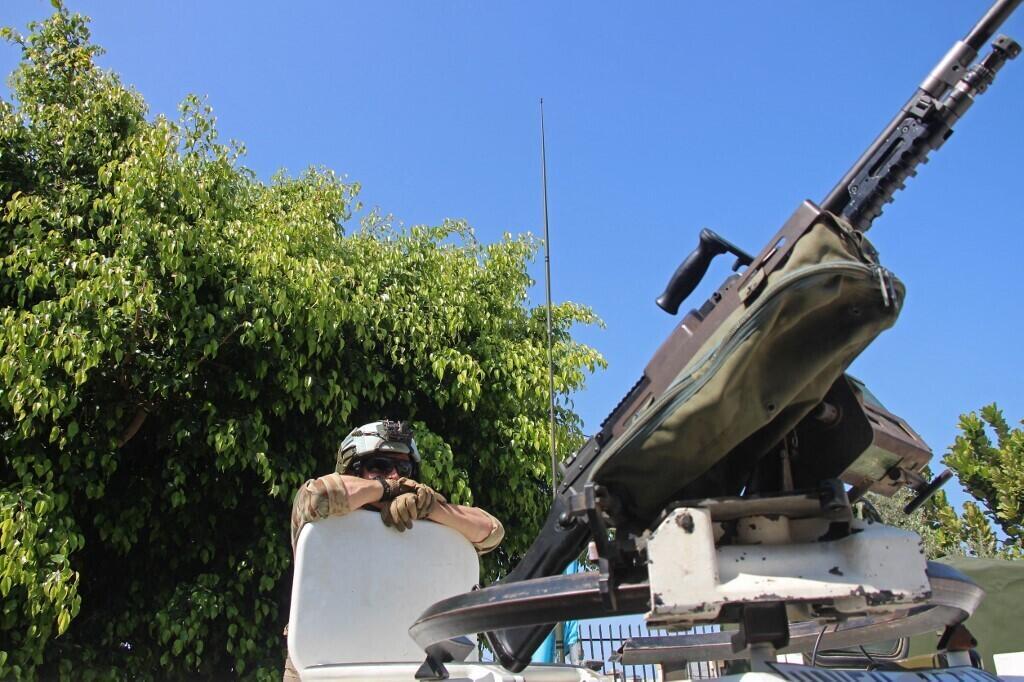 A member of the French contingent serving with the United Nations Interim Force in Lebanon (UNIFIL) stands guard on an armoured vehicle at the centre for the distribution of humanitarian aid among the displaced people, in the southern Lebanese village of Bourghliyeh on May 9, 2026.