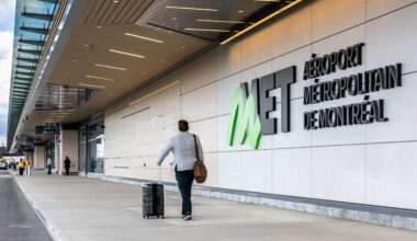 A traveller wheels a suitcase outside the Montreal Metropolitan Airport in St-Hubert.