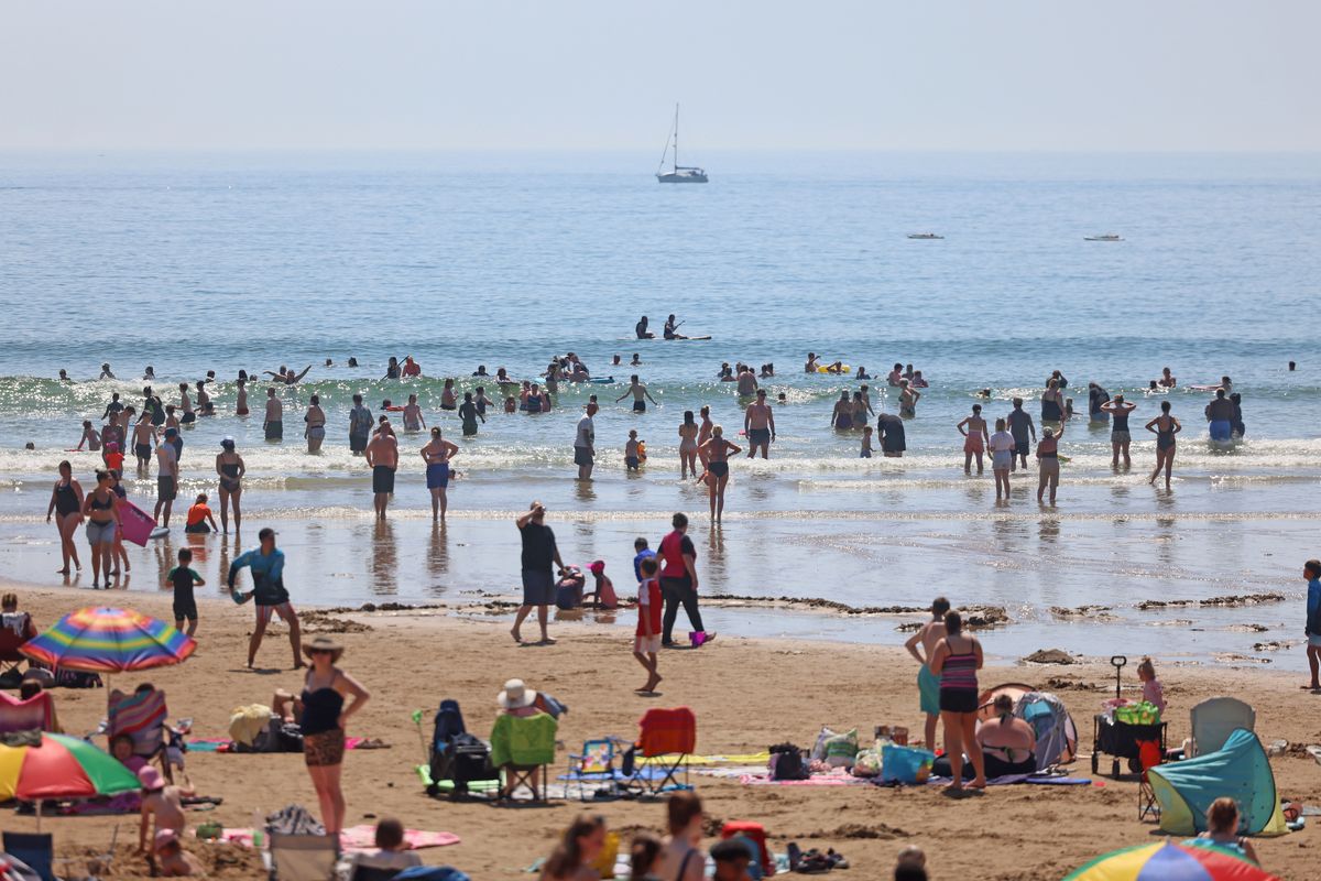 Visitors enjoy the sunshine at Caswell Bay