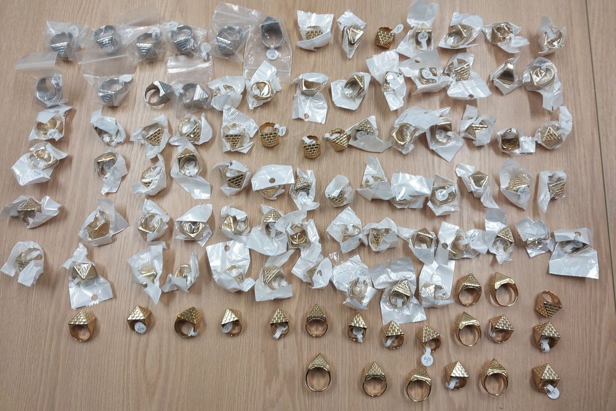 00 pyramid rings lined up in a police bust photo