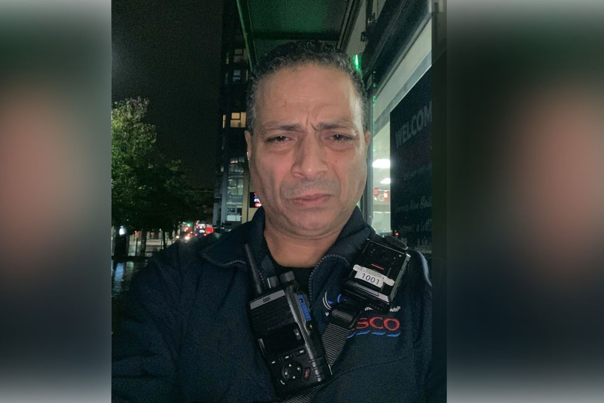 Mohamed Nasar wearing a Tesco security guard uniform looking straight into the camera
