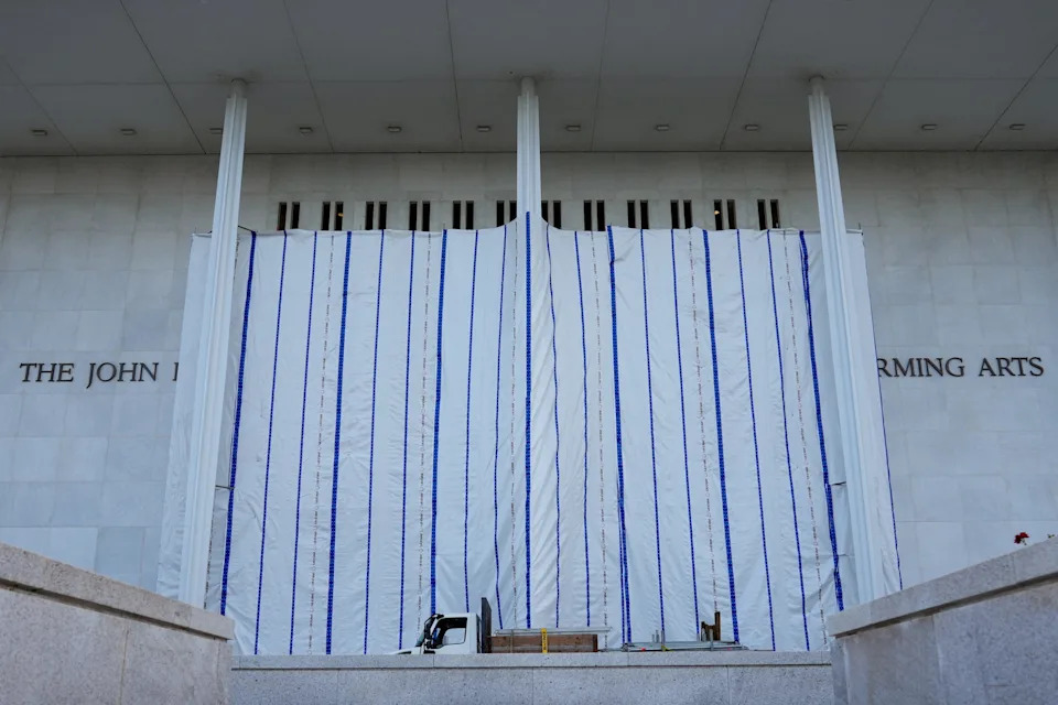 A tarp covers the facade of the John F. Kennedy Memorial Center for the Performing Arts, following a federal judge’s order to remove President Donald Trump's name from the institution, in Washington, D.C., on June 13, 2026.