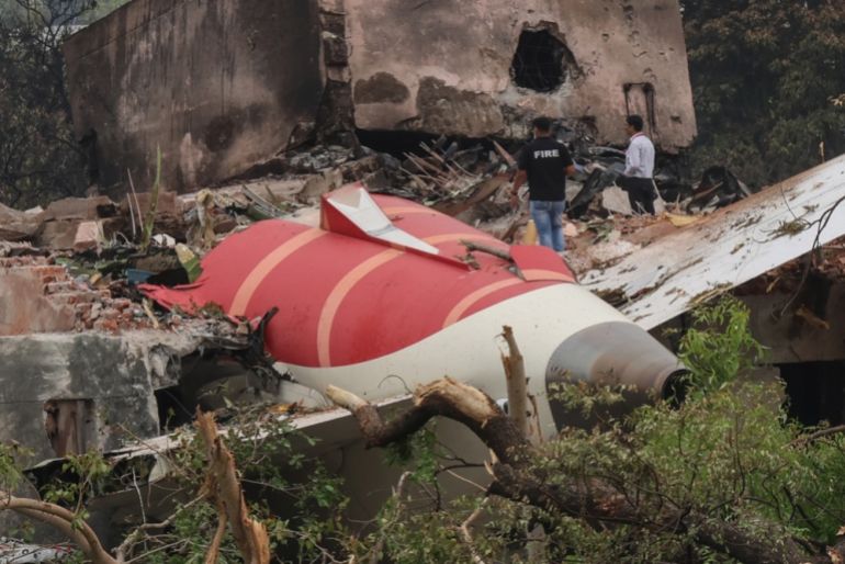 Officials inspect the site of an airplane crash near Sardar Vallabhbhai Patel International Airport in Ahmedabad, Gujarat, western India, 13 June 2025. [Rajat Gupta/EPA-EFE/
