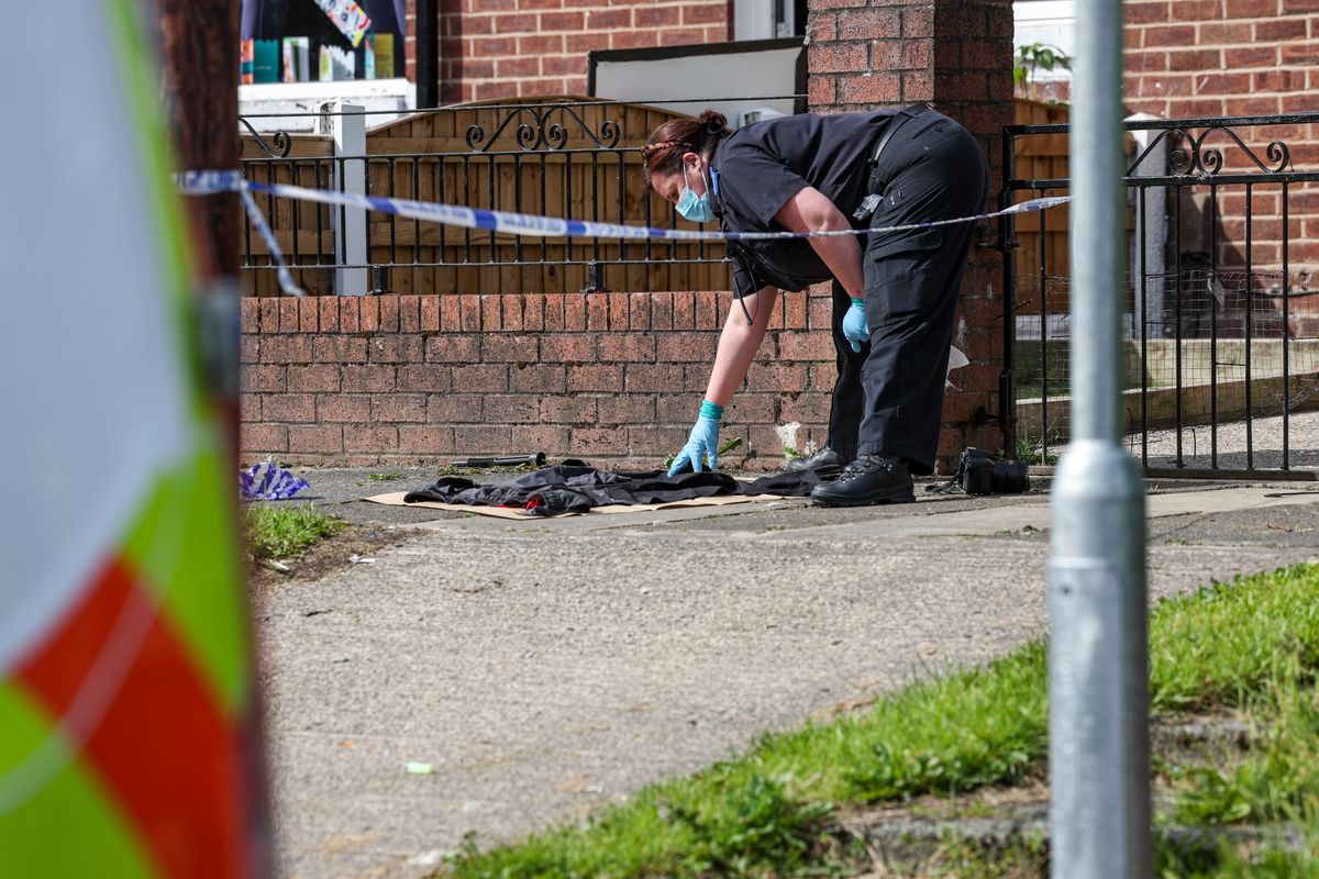 Forensics gather evidence from the scene of the Avon Road, Wigan stabbing