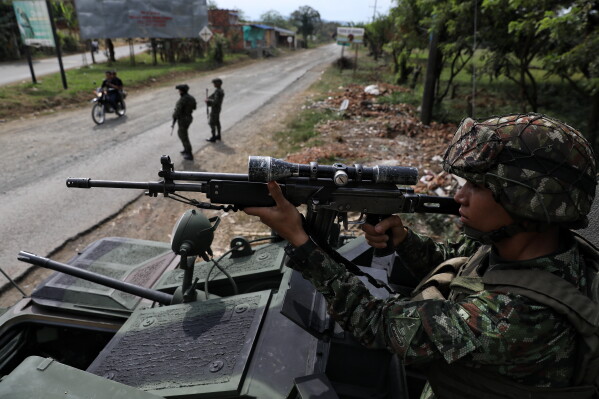 Soldiers guard during the presidential election in Santander de Quilichao, Colombia, Sunday, May 31, 2026. (AP Photo/Santiago Saldarriaga)