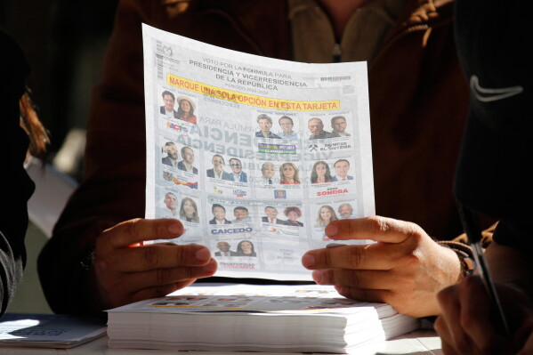 An election official holds a ballot during the presidential election in Rionegro, Colombia, Sunday, May 31, 2026 (AP Photo/Miguel Angel Lopez)