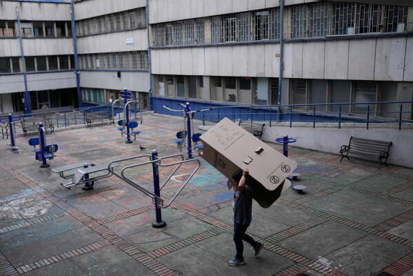 Election workers dismantle electoral booths after polls closed during the presidential election in Bogota, Colombia, Sunday, May 31, 2026.(AP Photo/Matias Delacroix)