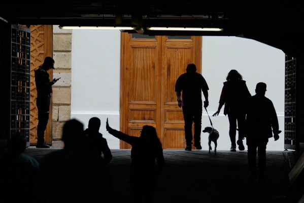 Voter leave a polling station during the presidential election in Bogota, Colombia, Sunday, May 31, 2026. (AP Photo/Matias Delacroix)