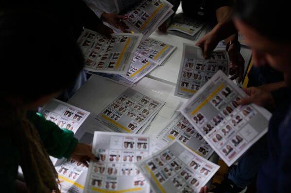 Election officials count ballots after polls closed during the presidential election in Bogota, Colombia, Sunday, May 31, 2026. (AP Photo/Matias Delacroix)