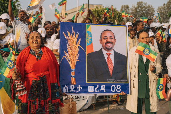 Supporters of Ethiopia's ruling party hold a large portrait of Prime Minister Abiy Ahmed at a rally ahead of the national elections in Addis Ababa, Ethiopia, Tuesday, May 26, 2026. (AP Photo/Amanuel Sileshi)