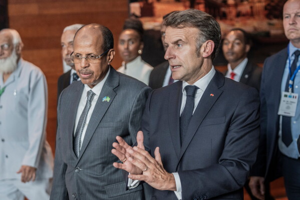 African Union Commission Chairperson Mahmoud Ali Youssouf and France's President Emmanuel Macron, right, interact at the African Union headquarters in Addis Ababa, Ethiopia, Wednesday, May 13, 2026. (AP Photo/Amanuel Sileshi)