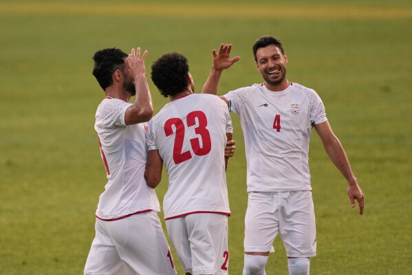 Iran's Ramin Rezaeian, center, celebrates with teammates after scoring their side's second goal during a friendly soccer match between Iran and Gambia, in Antalya, southern Turkey, Friday, May 29, 2026. (AP Photo/Khalil Hamra)