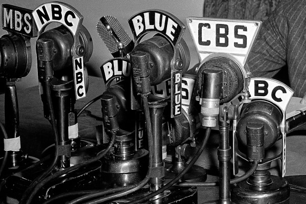Network microphones on the desk as President Franklin D. Roosevelt addresses the nation from the White House in Washington on April 28, 1942. (AP Photo/File)