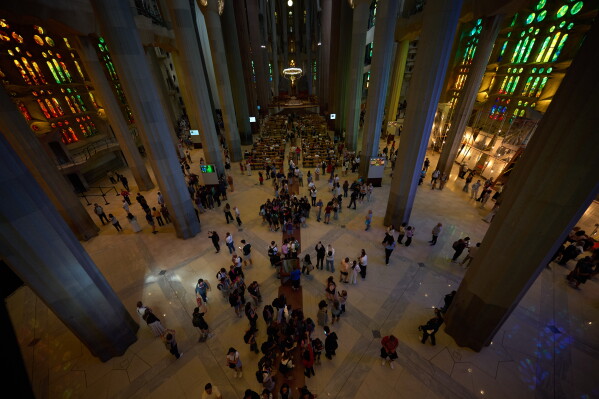 Visitors gather inside Antoni Gaudí's Sagrada Família basilica in Barcelona, Spain, Wednesday, May 20, 2026, ahead of Pope Leo XIV's visit to the city in June. (AP Photo/Emilio Morenatti)