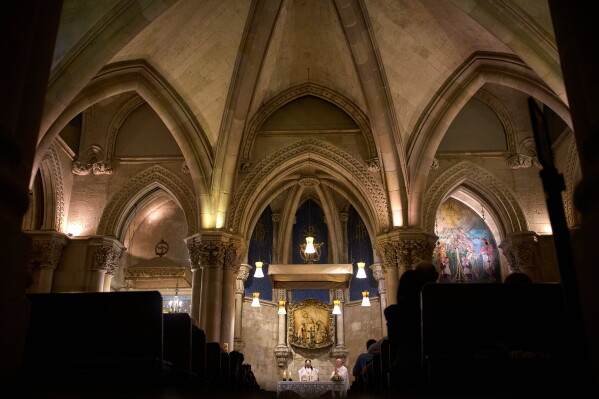 Parishioners attend Mass in the crypt of Antoni Gaudí's Basilica of the Sagrada Familia in Barcelona, Spain, Friday, May 15, 2026 ahead of Pope Leo XIV's visit to the city in June. (AP Photo/Emilio Morenatti)