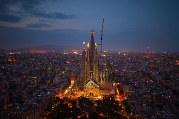 Antoni Gaudí's Basilica of the Sagrada Familia stands at dusk in Barcelona, Spain, Saturday, May 30, 2026, ahead of Pope Leo XIV's visit to Barcelona in June. (AP Photo/Emilio Morenatti)