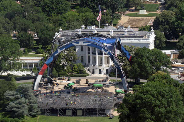 Workers build the cage for a UFC fight on the South Lawn in front of the White House. (AP Photo/Jose Luis Magana)