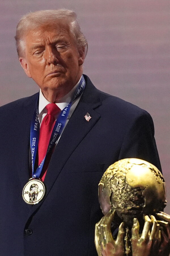 President Donald Trump stands on stage after receiving the FIFA Peace Prize. (AP Photo/Jacquelyn Martin, file)