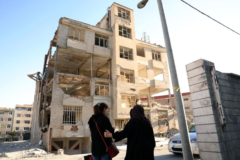 epa13011956 Iranian women walk in front of a residential building, destroyed by previous US-Israeli airstrikes, in Tehran, Iran, 02 June 2026. The Iranian Foreign Minister stated that the agreement between Iran and the US is 'a ceasefire on all fronts, including in Lebanon,' warning that its breach on one front constitutes a 'violation of the ceasefire on all fronts.' EPA/ABEDIN TAHERKENAREH RESTRICTIONS: NO Access Israel Media/Persian Language TV Stations Outside Iran/Strictly No Access BBC Persian/VOA Persian/Manoto TV/Iran International TV. (As mandated by Iran's Directorate General for Foreign Media) --