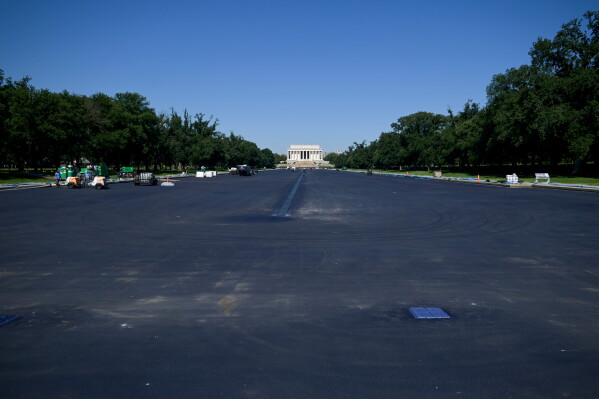 Work continues on the Lincoln Memorial Reflecting Pool, which is covered in a blue protective coating, ahead of the United States 250th anniversary, Thursday, June 4, 2026, in Washington. (AP Photo/Rod Lamkey, Jr.)
