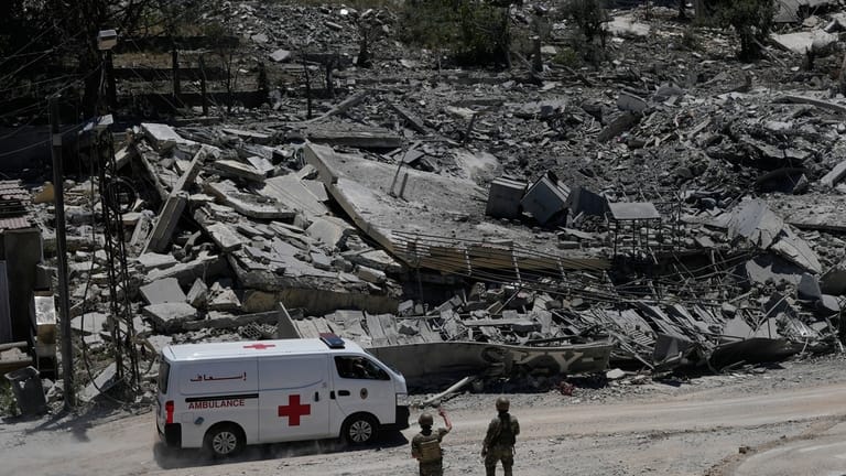 Lebanese soldiers deploy at a road in front of destroyed...