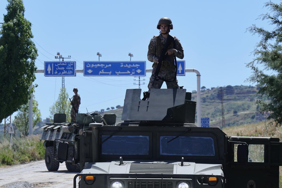 Israeli Army engineering vehicles clears the road by removing piles of dirt and rubble
