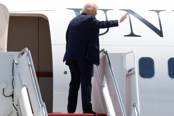President Donald Trump waves from the stairs of Air Force One upon his arrival at Joint Base Andrews, Md., Friday, June 5, 2026. (AP Photo/Luis M. Alvarez)