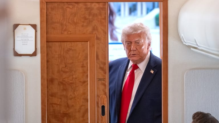 President Donald Trump arrives to speak to reporters aboard Air...
