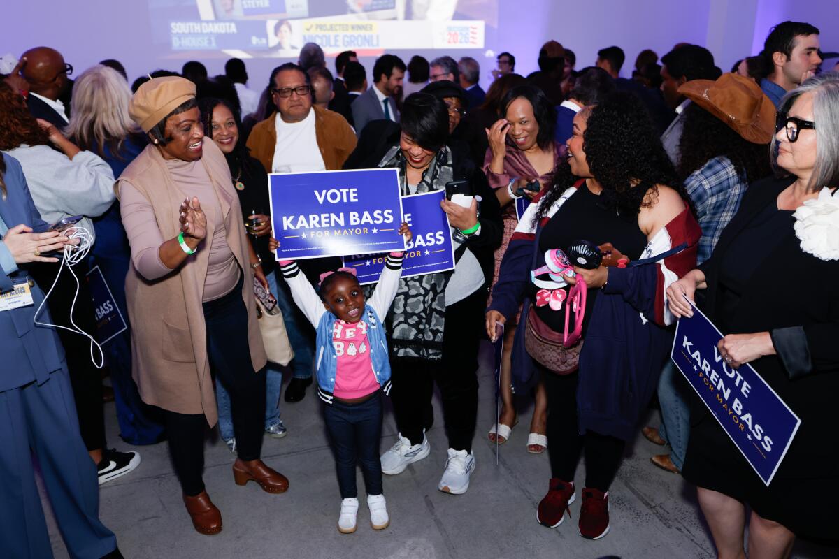 People with pro-Bass signs attend Mayor Bass' election party for the California 2026 primaries at a hotel.