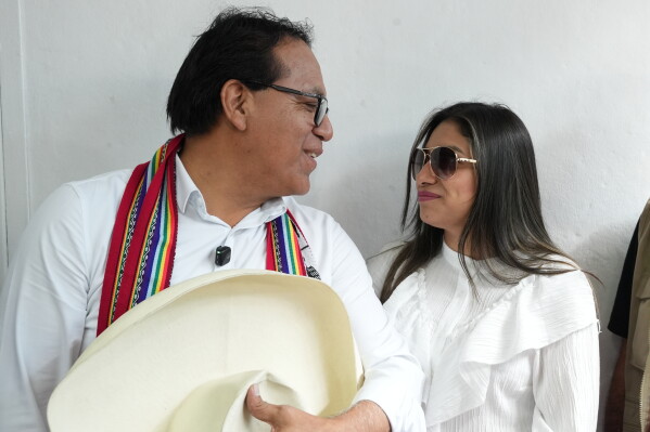 Presidential candidate Roberto Sanchez of the Together for Peru party looks at his wife Claudia Pinazzo before voting during the presidential runoff election in Lima, Peru, Sunday, June 7, 2026. (AP Photo/Miguel Paredes)