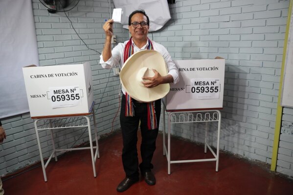 Presidential candidate Roberto Sanchez of the Together for Peru party displays his ballot during the presidential runoff election in Lima, Peru, Sunday, June 7, 2026. (AP Photo/Miguel Paredes)