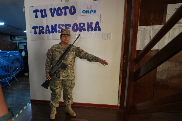 A soldier guards a polling station during the presidential runoff election in Lima, Peru, Sunday, June 7, 2026. (AP Photo/Rodrigo Abd)