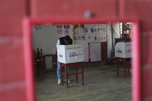A voter marks his ballot during the presidential runoff election in Lima, Peru, Sunday, June 7, 2026. (AP Photo/Rodrigo Abd)