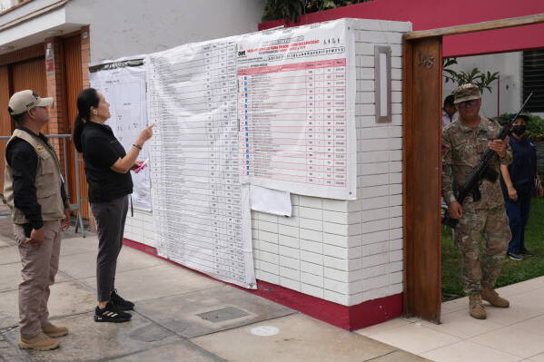 A soldier guard a polling station during the presidential runoff election in Lima, Peru, Sunday, June 7, 2026. (AP Photo/Rodrigo Abd)