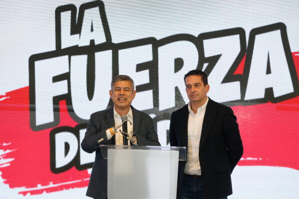 Luis Galarreta, the vice-presidential running mate of Keiko Fujimori, and Senator-elect Miguel Angel Torres, right, speak after polls closed in the presidential runoff election in Lima, Peru, Sunday, June 7, 2026. (AP Photo/Martin Mejia)