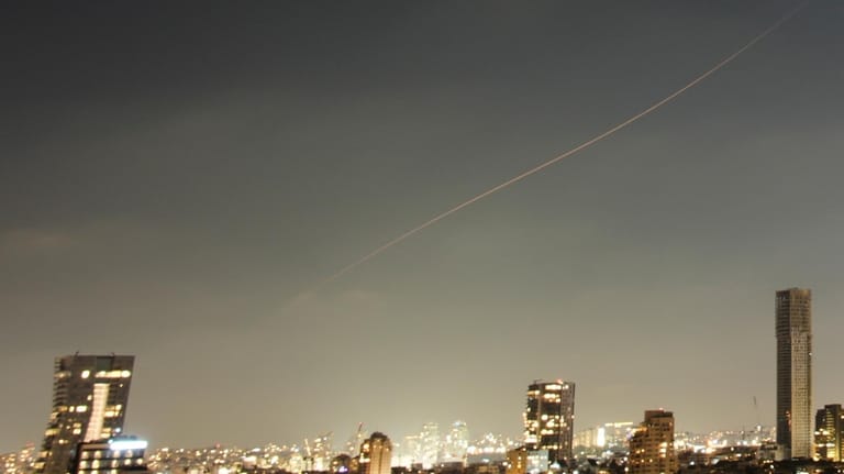 A projectile streaks through the sky over central Israel during...