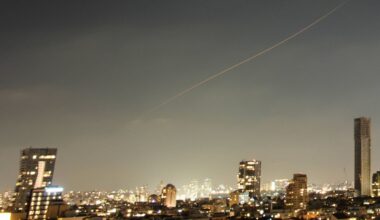 A projectile streaks through the sky over central Israel during an Iranian missile attack, Sunday, June 7, 2026. (AP Photo/Ohad Zwigenberg)