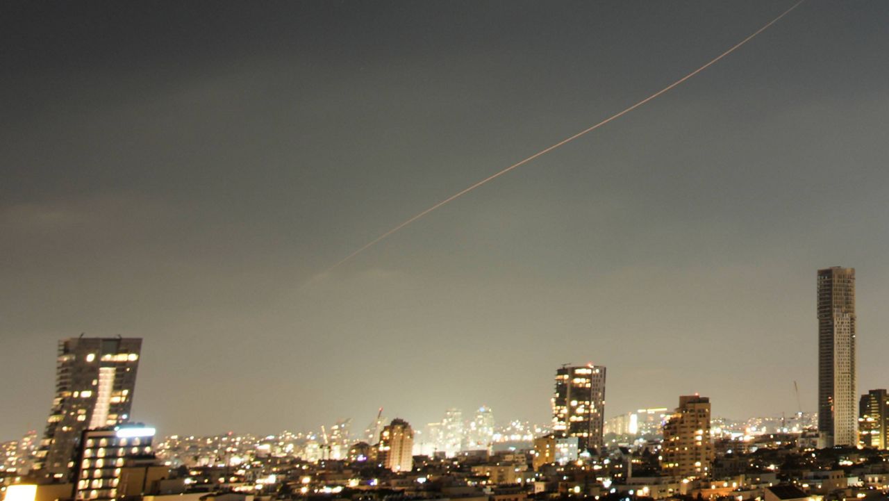 A projectile streaks through the sky over central Israel during an Iranian missile attack, Sunday, June 7, 2026. (AP Photo/Ohad Zwigenberg)