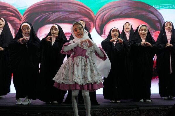 Iranian girls perform during a pro-government gathering in Tehran, Iran, Sunday, June 7, 2026. (AP Photo/Vahid Salemi)