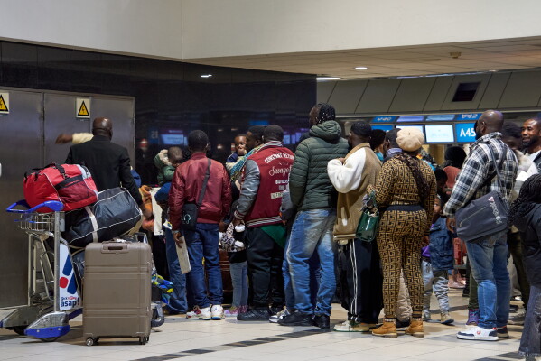 Ghanaian nationals queue with their luggage at O.R. Tambo International Airport as they prepare to board a repatriation flight home following unrest concerns in Johannesburg, South Africa, Wednesday, May 27, 2026. (AP Photo/Kayleen Morgan)