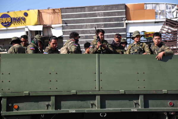 Soldiers secure a damaged building following an earthquake in General Santos, Philippines Tuesday, June 9, 2026. (AP Photo/Basilio Sepe)