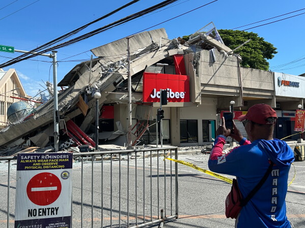 Residents takes a picture of a collapsed structure following an earthrquake, in General Santos, Philippines on Monday, June 8, 2026. (AP Photo)