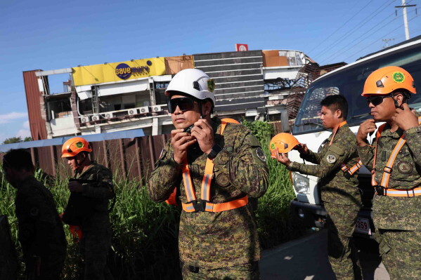 Rescuers prepare for a search operation following an earthquake in General Santos, Philippines Tuesday, June 9, 2026. (AP Photo/Basilio Sepe)