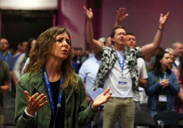Messengers attending the Southern Baptist Convention participate in worship during the 2025 SBC Annual Meeting, June 10, 2025, in Dallas. (AP Photo/Richard W. Rodriguez, File)