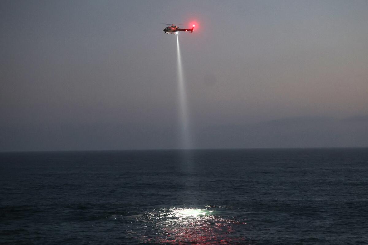 A Sheriff's helicopter searches the shoreline.