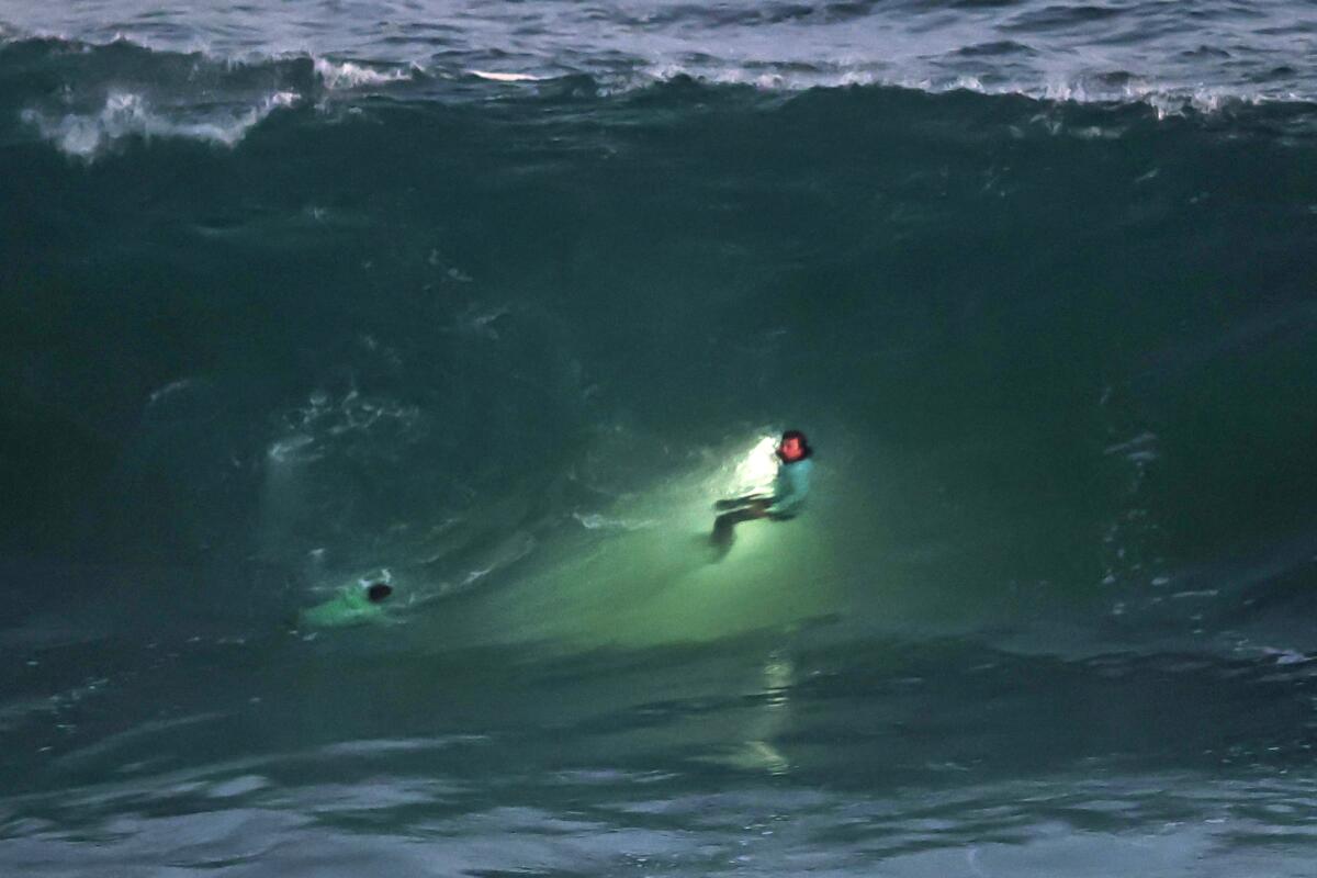 Laguna Beach lifeguards search the turbulent waters.
