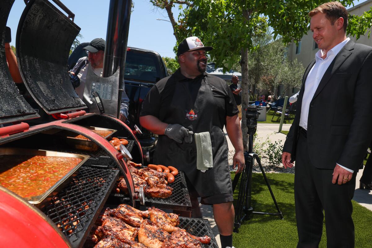 Keith Casey of Casey's Family BBQ serves up food as LA Mayoral candidate Spencer Pratt hosts a campaign "block party" event