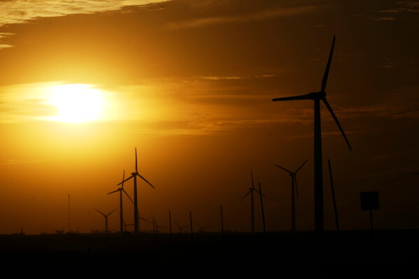 Wind turbines are visible as the sun begins to set Feb. 26, 2025, in Roscoe, Texas. (AP Photo/Julio Cortez, File)