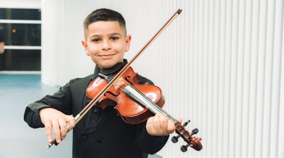 Youssef Sarhan, a 9-year-old violinist from Majd al-Krum, participates in The Jerusalem Orchestra East & West’s youth initiative.