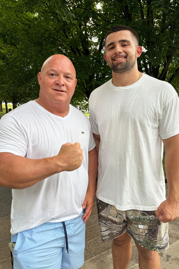 Tracy Philbeck and his son, Levi Philbeck, from Charlotte, N.C., pose for a photo at the Lincoln Memorial, Friday, June 12, 2026, in Washington. (AP Photo/Fatima Hussein)